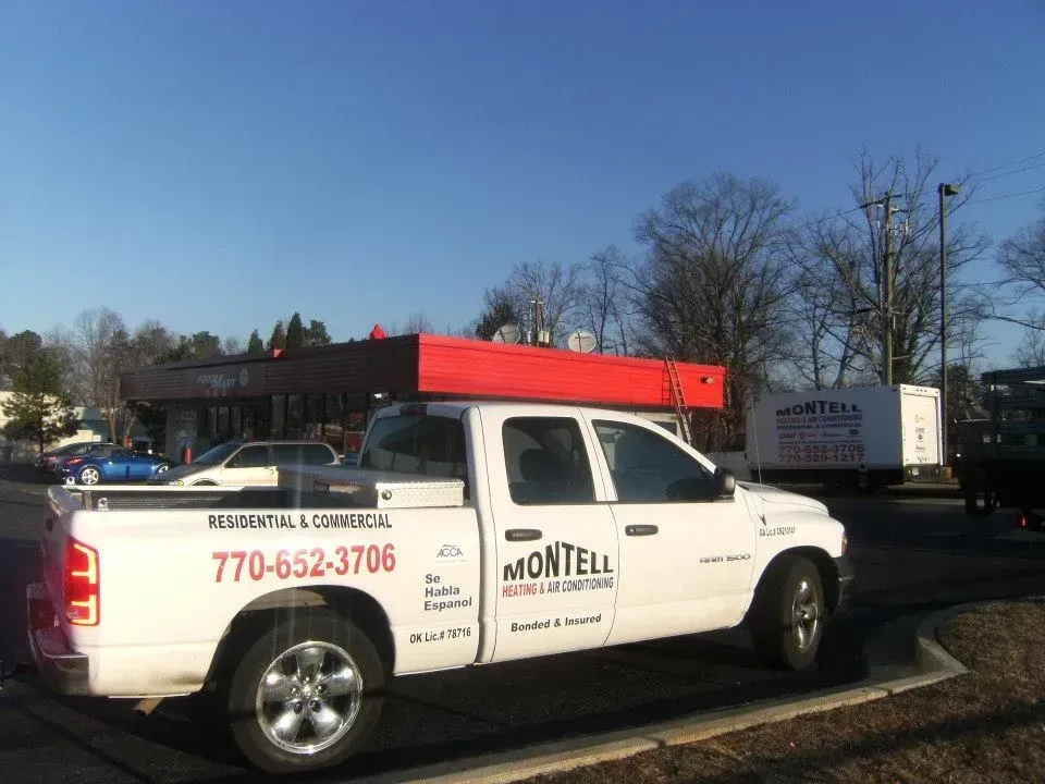 A white montell truck is parked in a parking lot