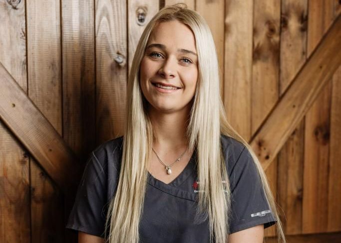Blonde woman smiling, wearing a dark gray top — Westlakes Veterinary Hospital in Fennell Bay, NSW