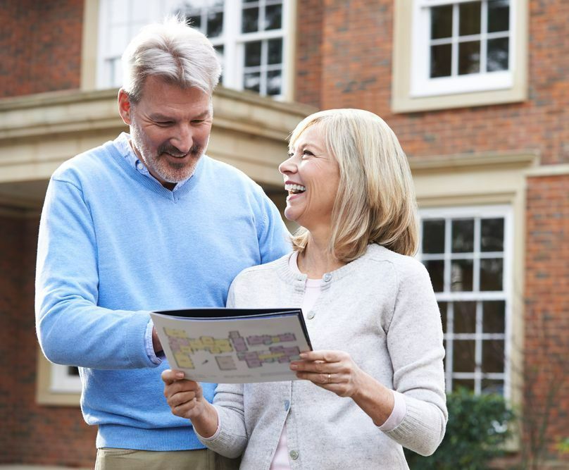 A Man and a Woman Are Looking at a Map — Peterson Property Valuations In Caloundra West, QLD
