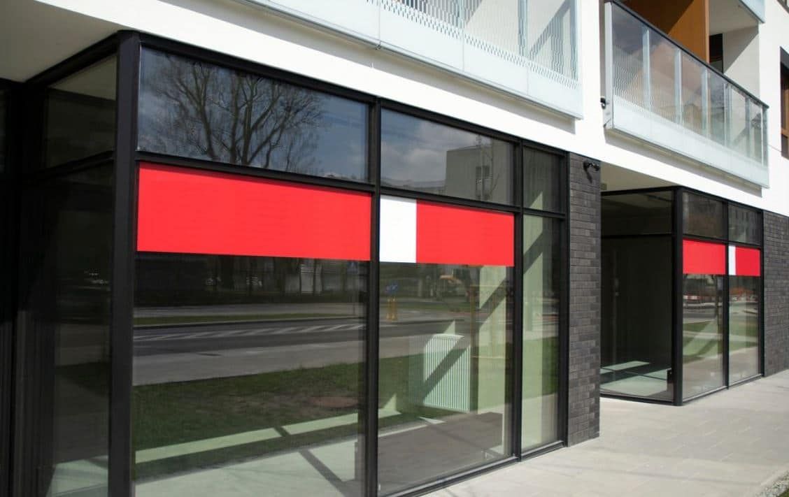A Building With Red and White Stripes on the Windows — Peterson Property Valuations In Caloundra West, QLD