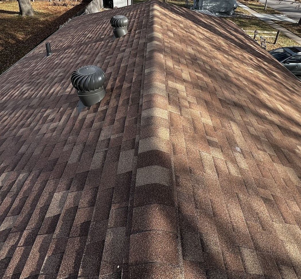 A close up of a roof with a few vents on it.