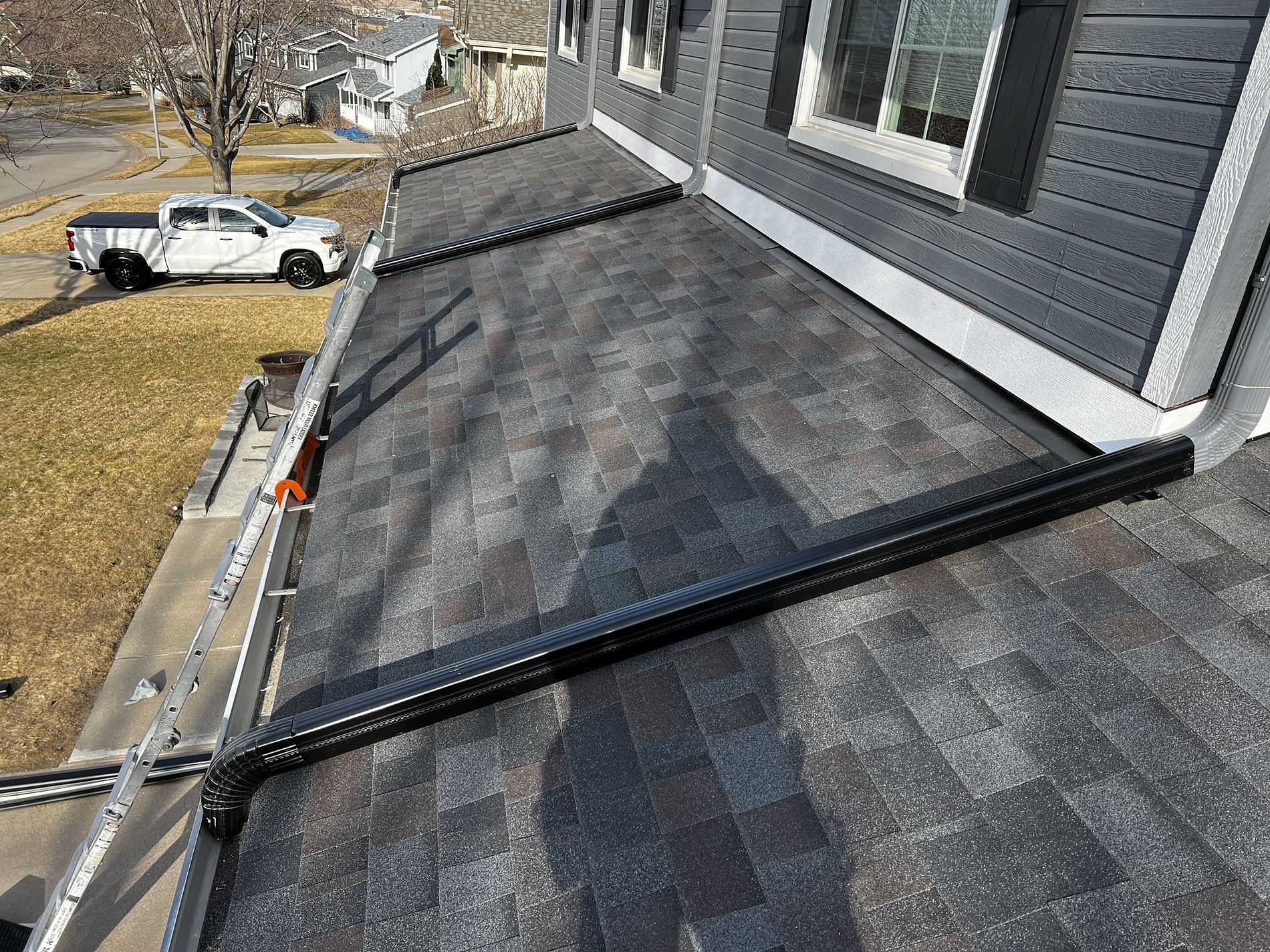 A truck is parked on the roof of a house.