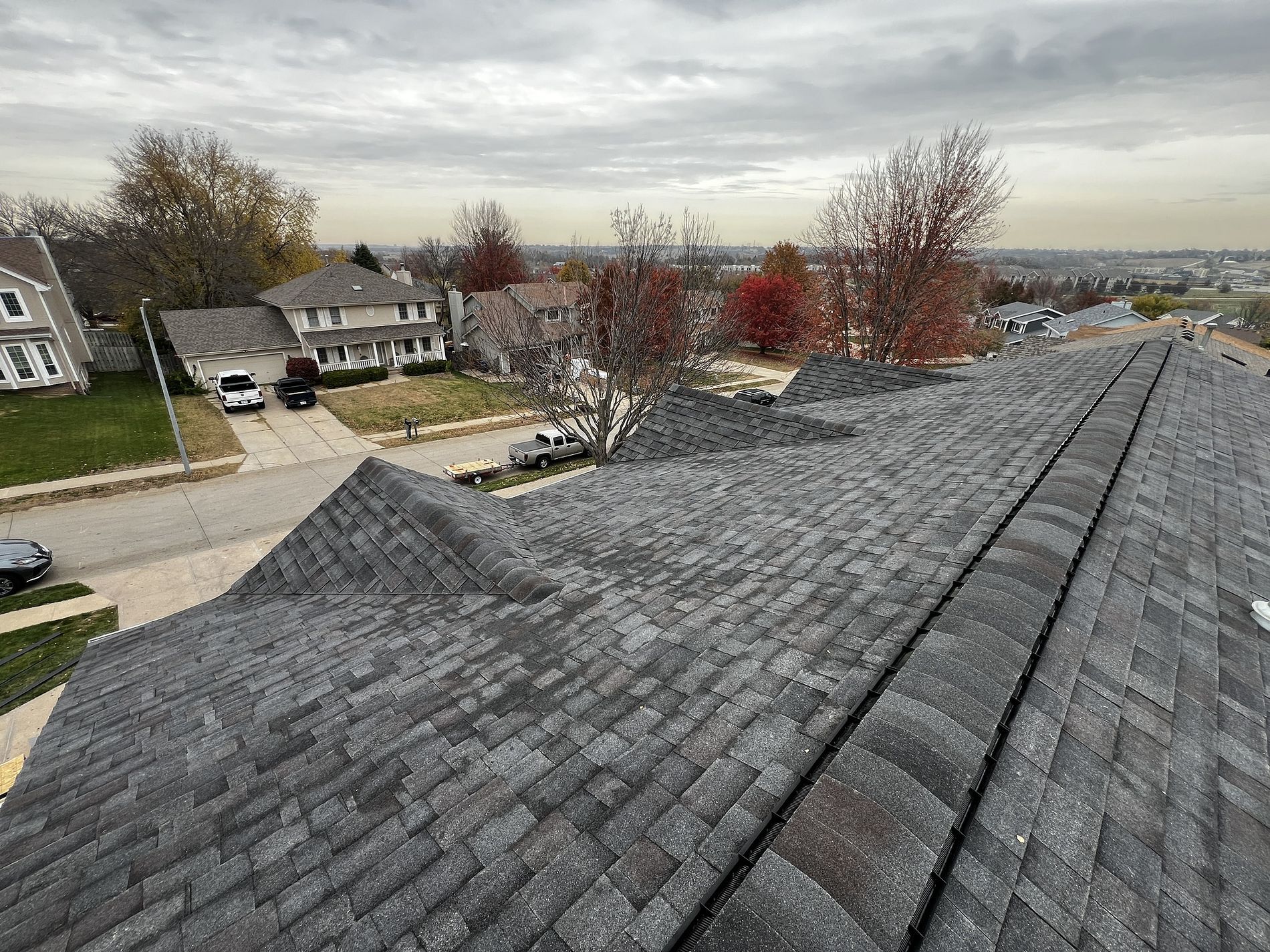 An aerial view of a roof of a house in a residential area.