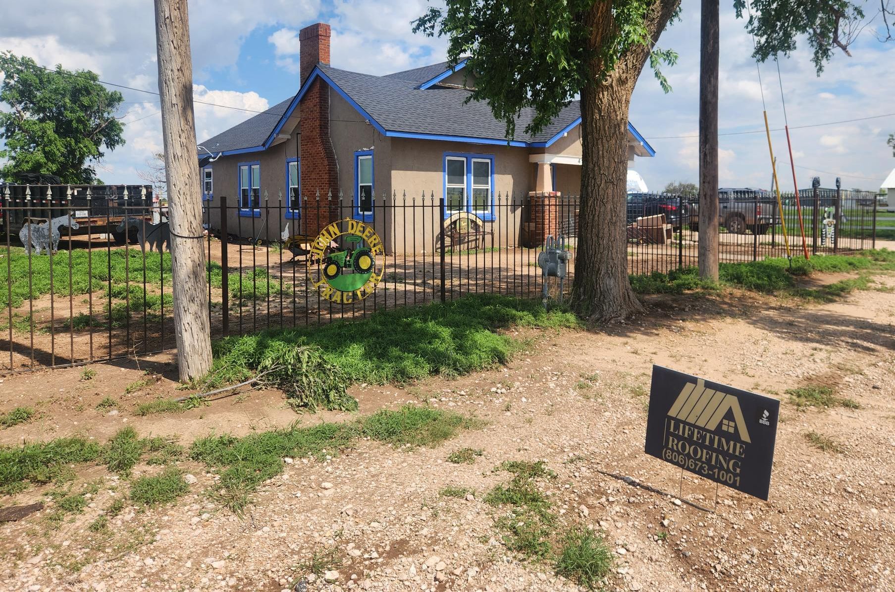 A house with a fence and a sign in front of it