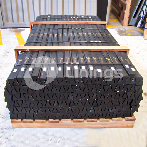 A wooden pallet with a bunch of rubber blocks on it