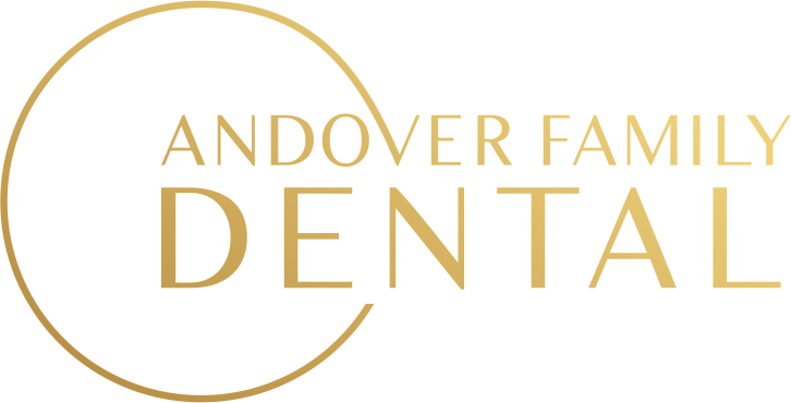 The logo for andover family dental has a gold circle around it.