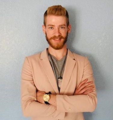 A woman with long brown hair is smiling for the camera.