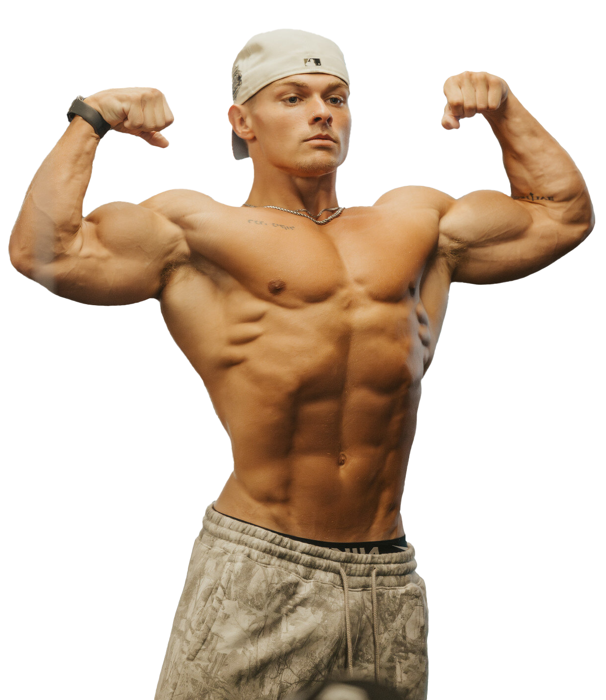 A shirtless man in a hat is flexing his muscles