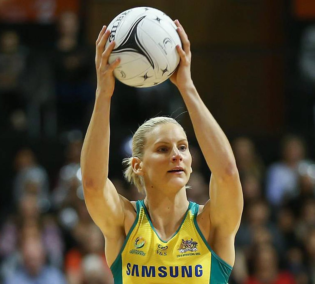 A female netball player wearing a samsung jersey is about to throw the ball