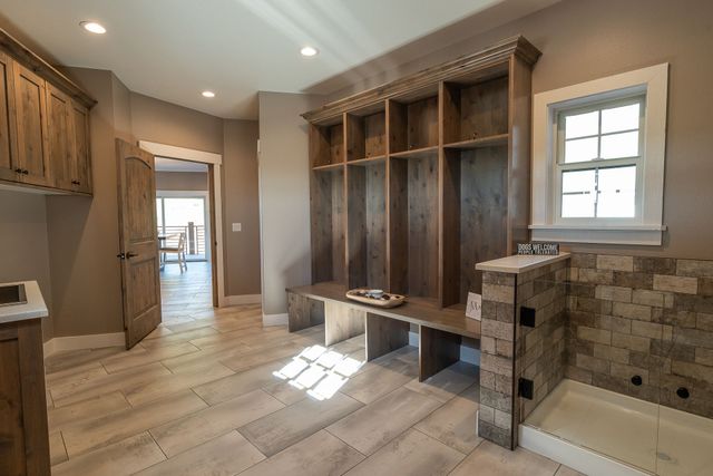 A kitchen with white cabinets and a large island in the middle.