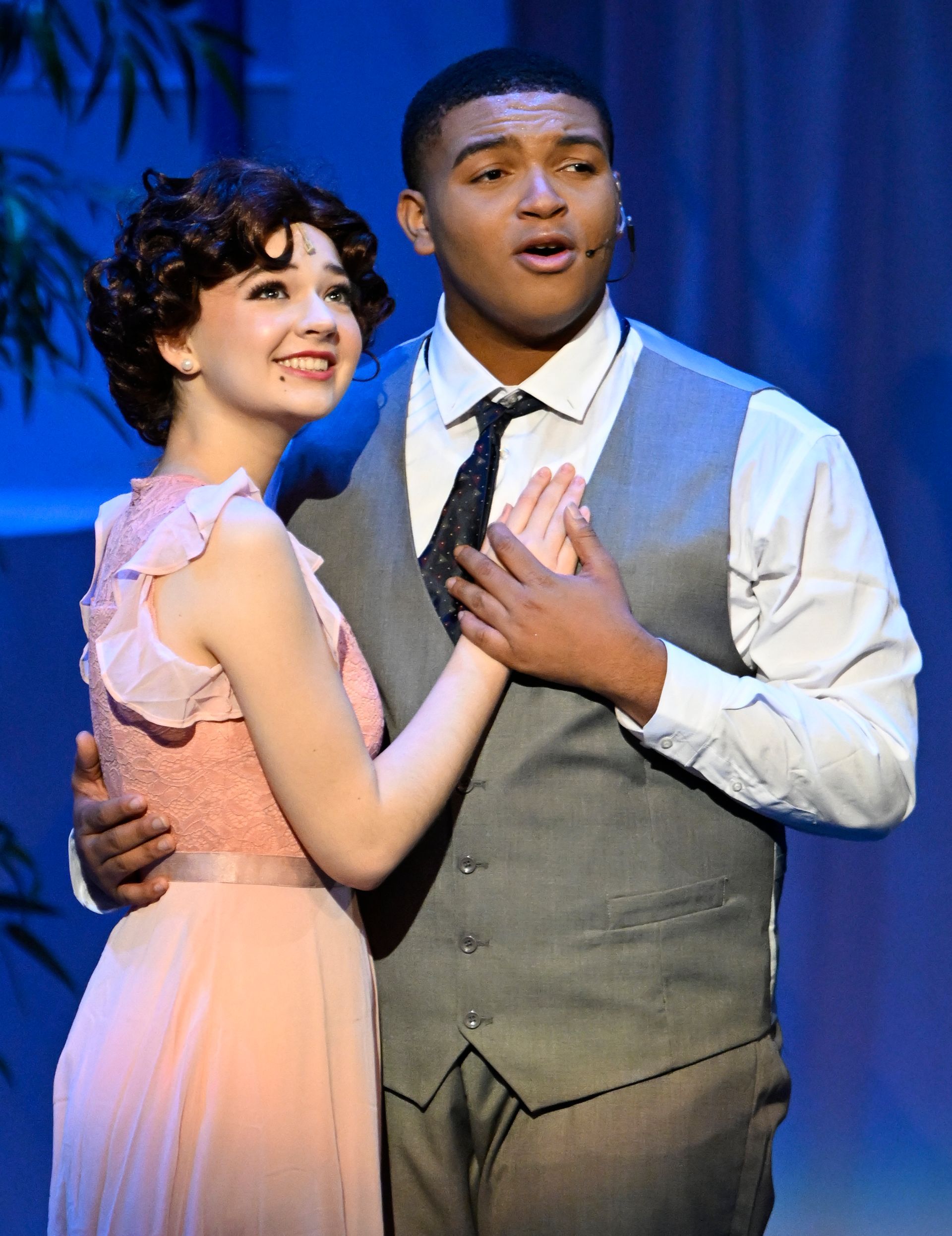 a man and a woman are standing next to each other on a stage .