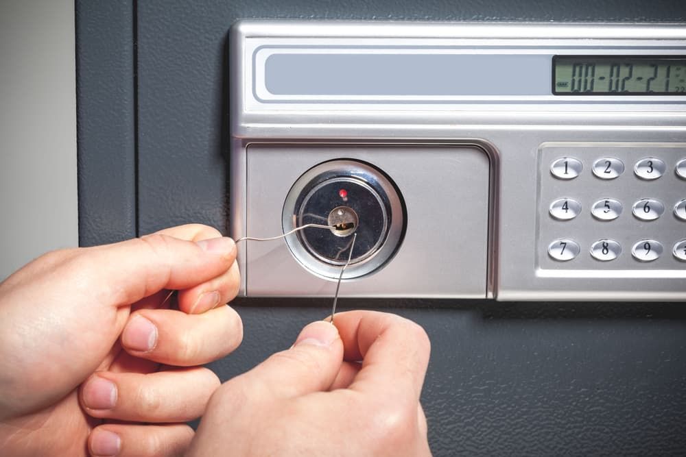 Individual Attempting to Unlock a Safe Using a Key - Locksmith Services in Orange, NSM