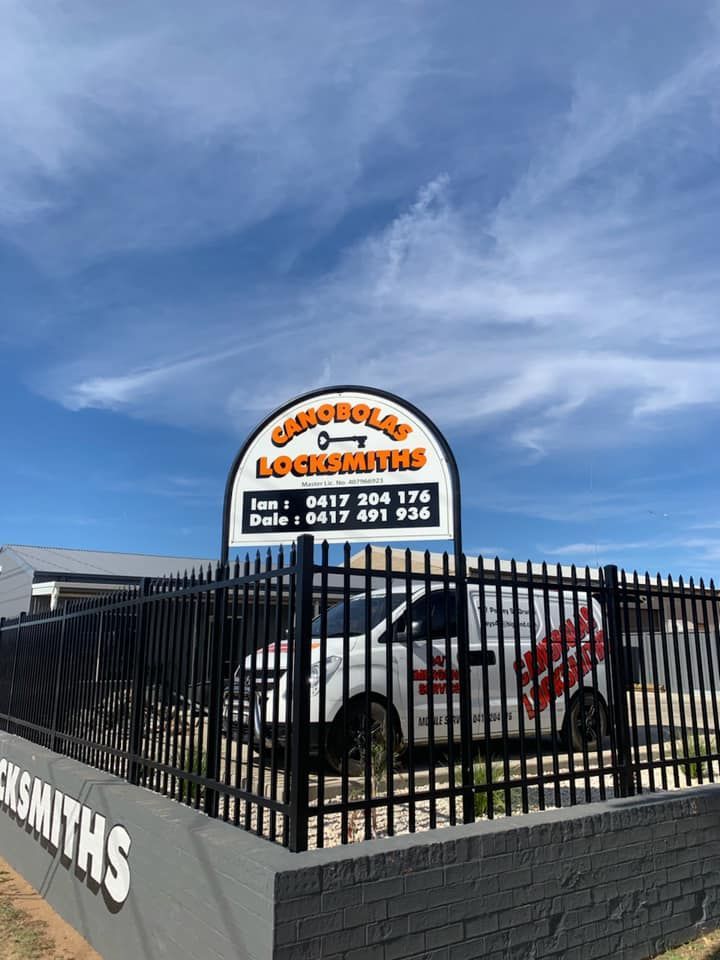 A White Van Parked in Front of Canobolas Locksmiths Sign - Locksmith Services in Orange, NSM