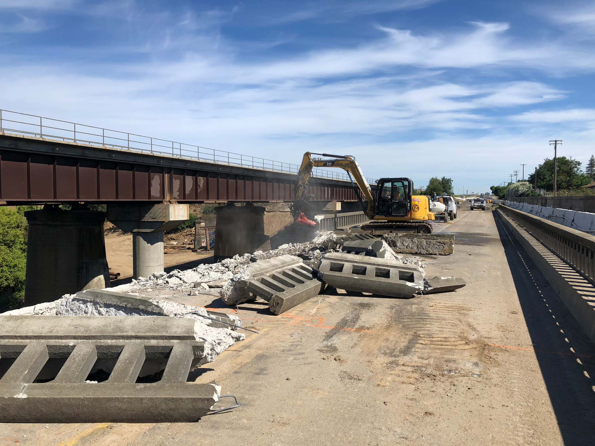 A Construction Site With a Bridge in the Background — Chicago, IL — Sterling Holloway Demolition