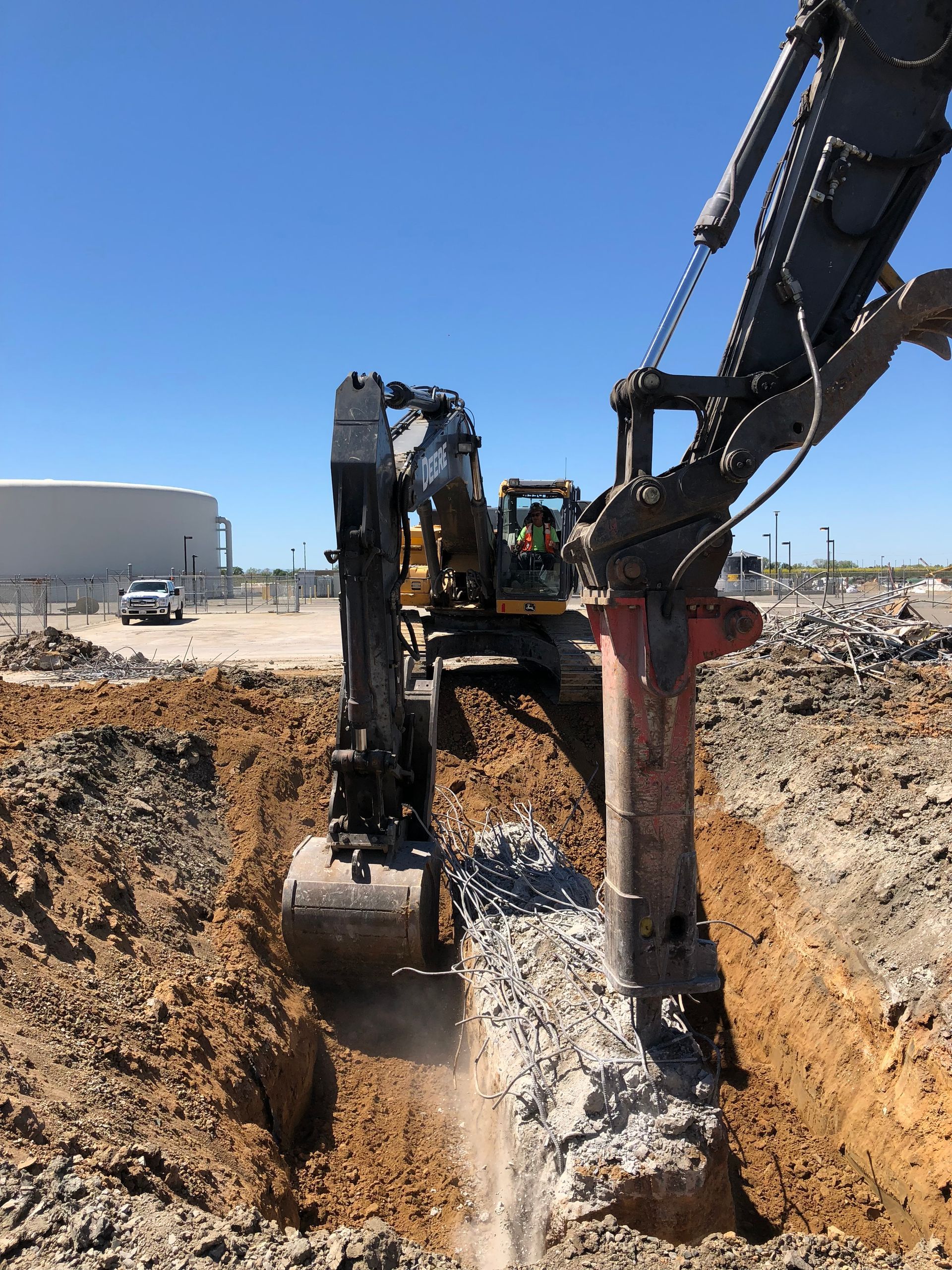 A Large Excavator Is Digging a Hole in the Ground — Chicago, IL — Sterling Holloway Demolition
