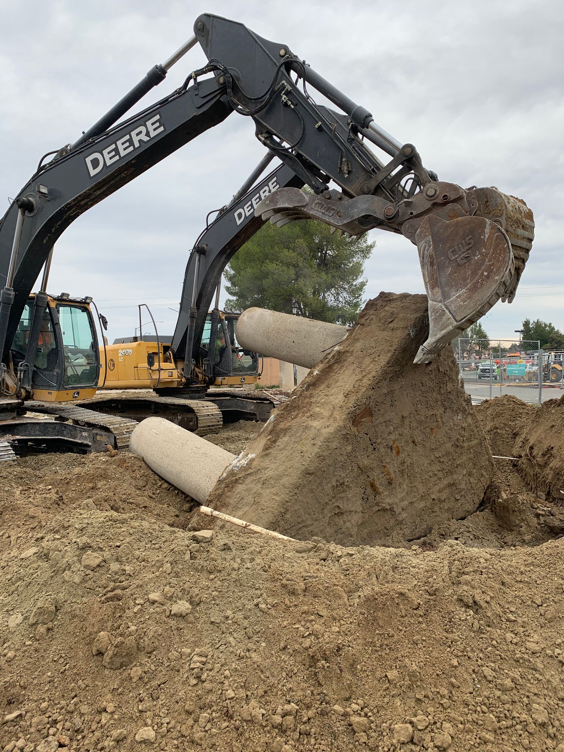 A Couple of Excavators Are Digging a Hole in the Ground — Chicago, IL — Sterling Holloway Demolition