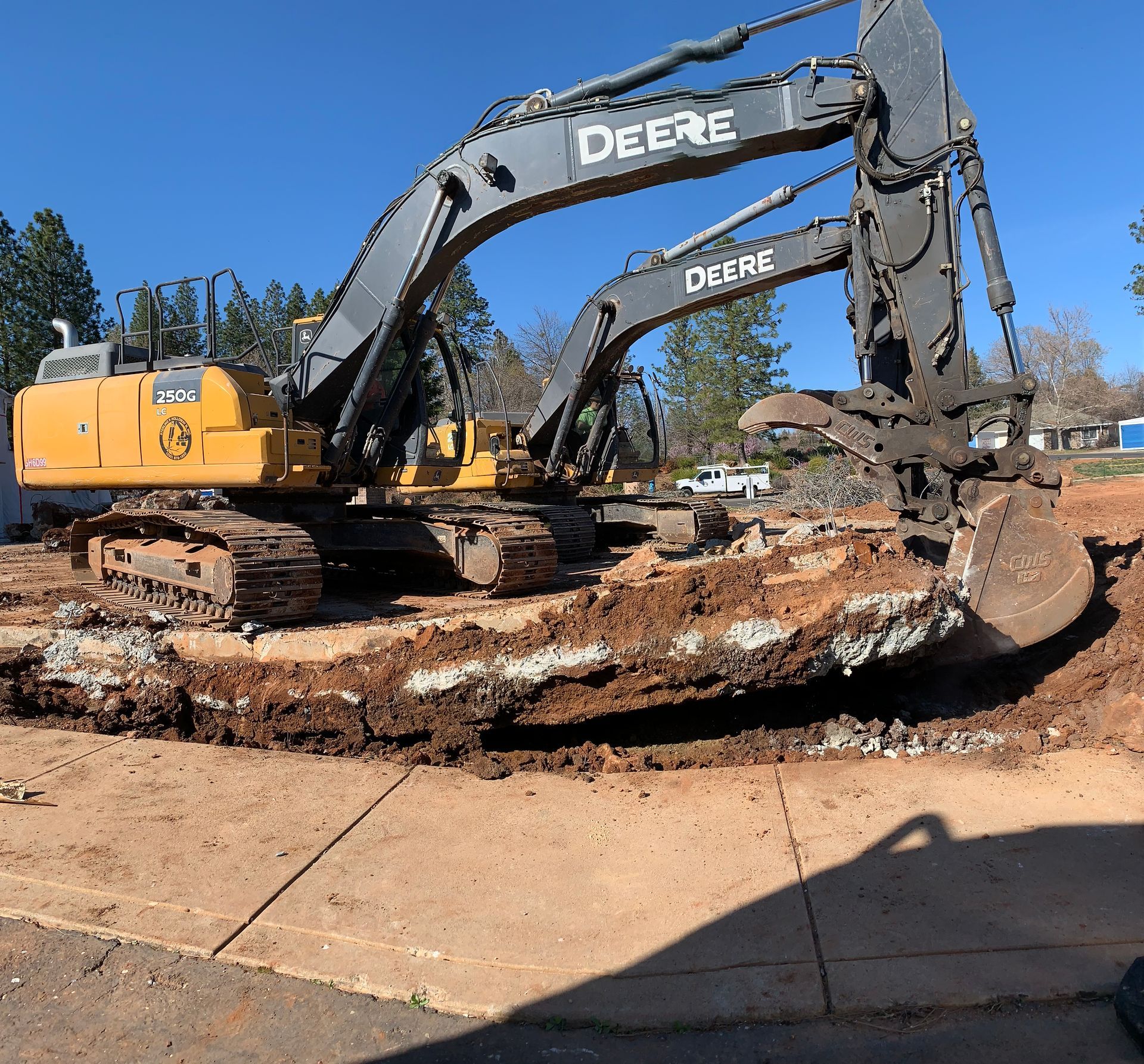 A Deere Excavator Is Digging a Hole in the Ground — Chicago, IL — Sterling Holloway Demolition