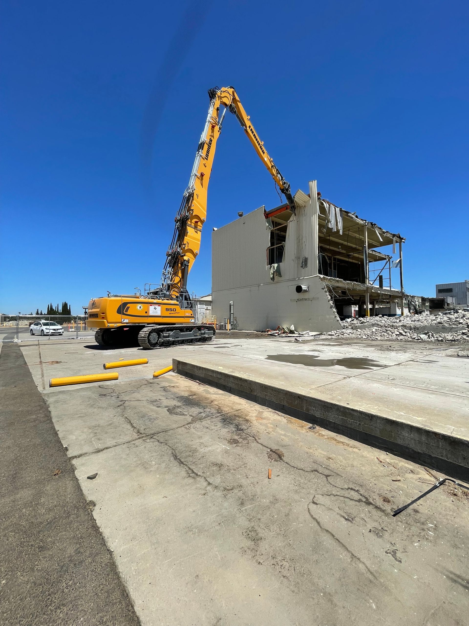A Large Yellow Crane Is Demolishing a Building — Chicago, IL — Sterling Holloway Demolition