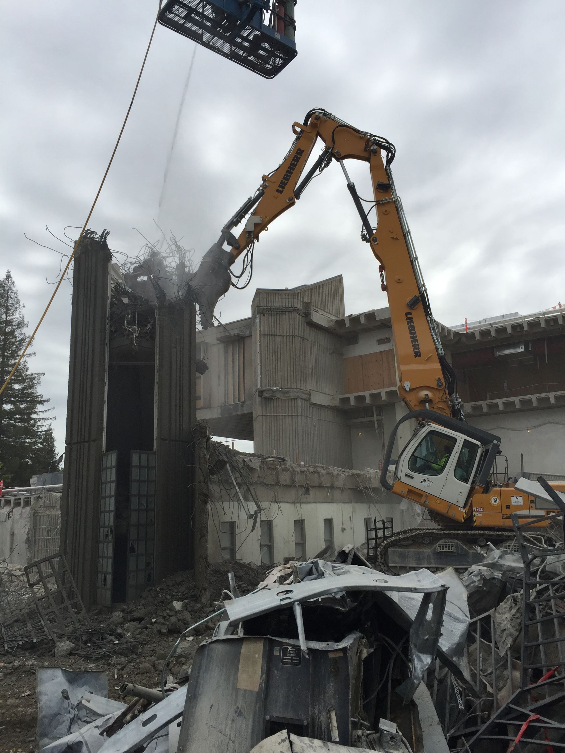 A Large Yellow Excavator Is Demolishing a Bridge — Chicago, IL — Sterling Holloway Demolition