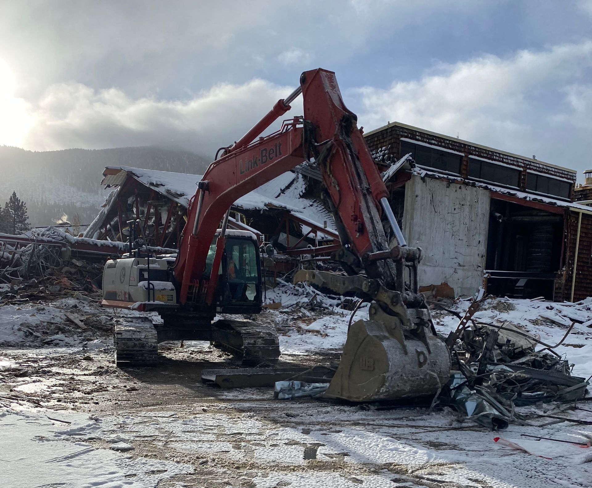 An Excavator Is Demolishing a Building in the Snow — Chicago, IL — Sterling Holloway Demolition