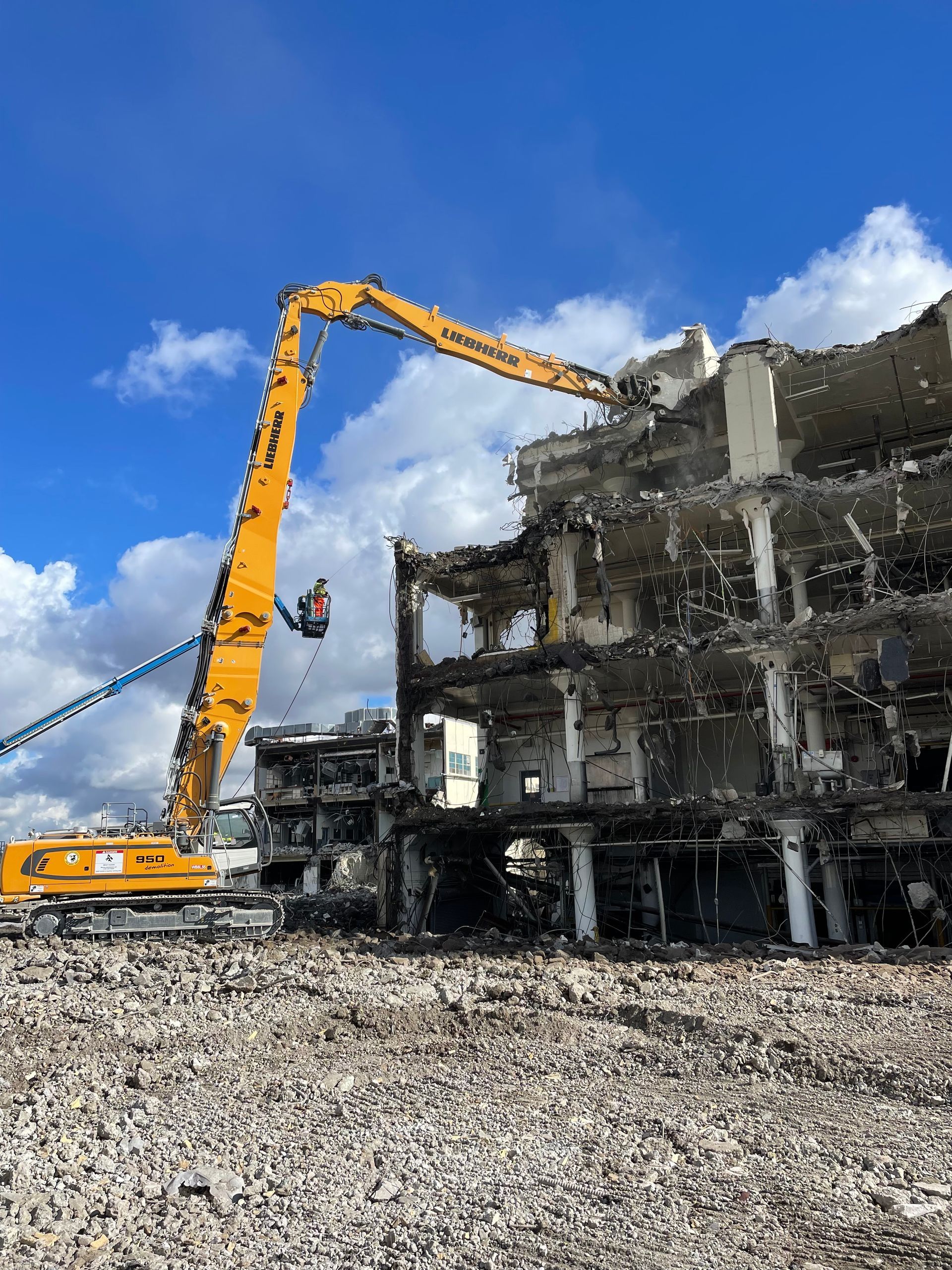 A Large Yellow Crane Is Demolishing a Building — Chicago, IL — Sterling Holloway Demolition