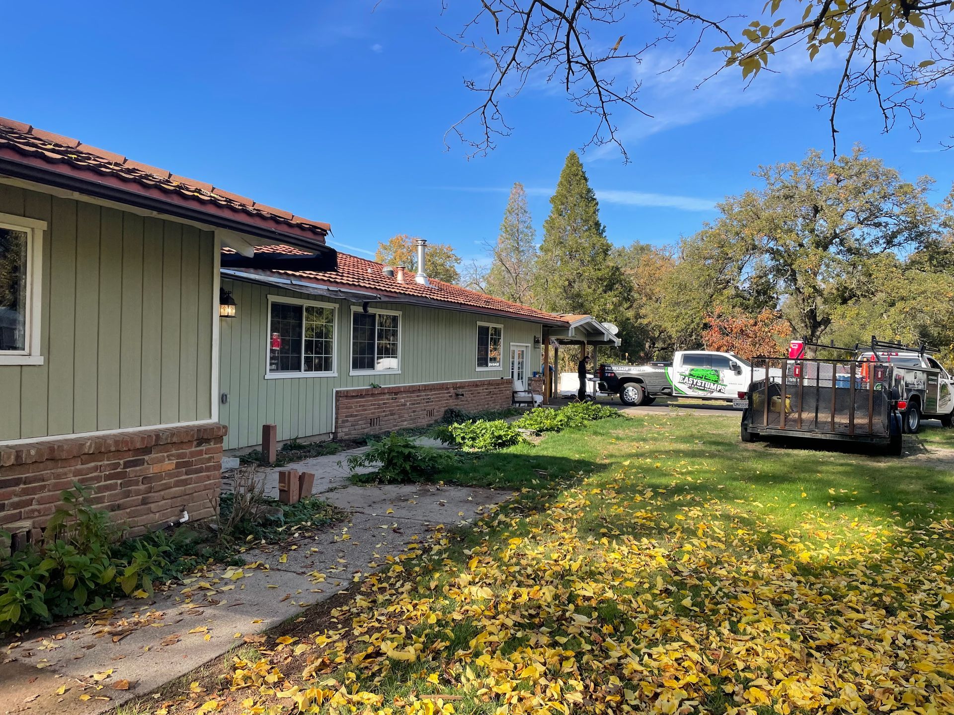 A Green House With a Truck Parked in Front of It — Chicago, IL — Sterling Holloway Demolition