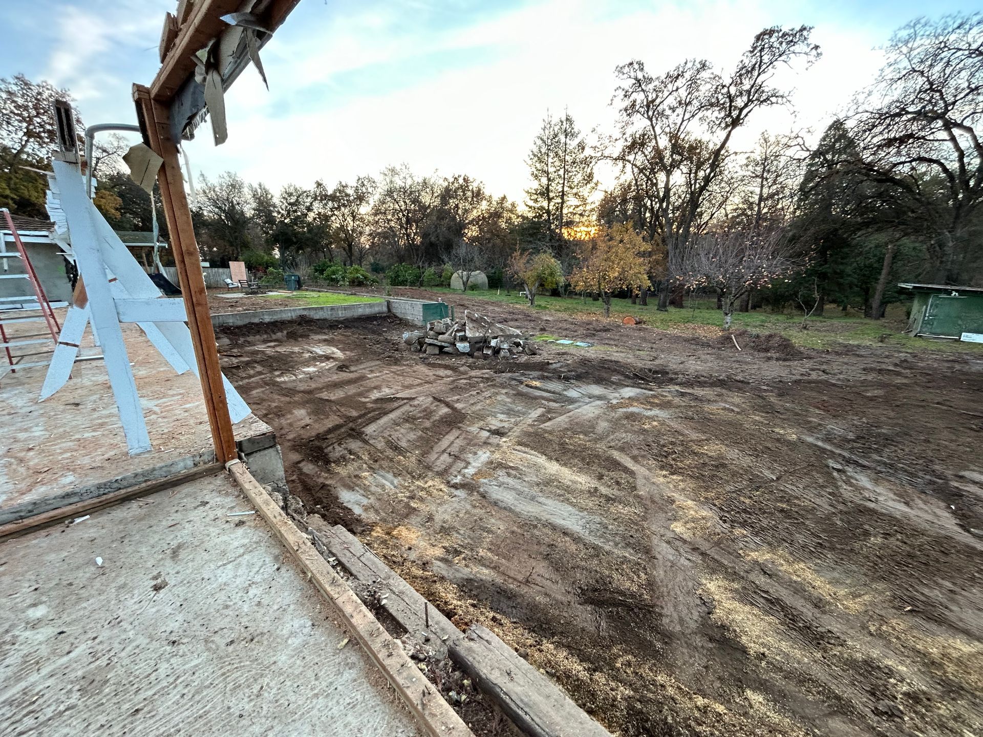 A Construction Site With a Lot of Dirt and Trees in the Background — Chicago, IL — Sterling Holloway Demolition