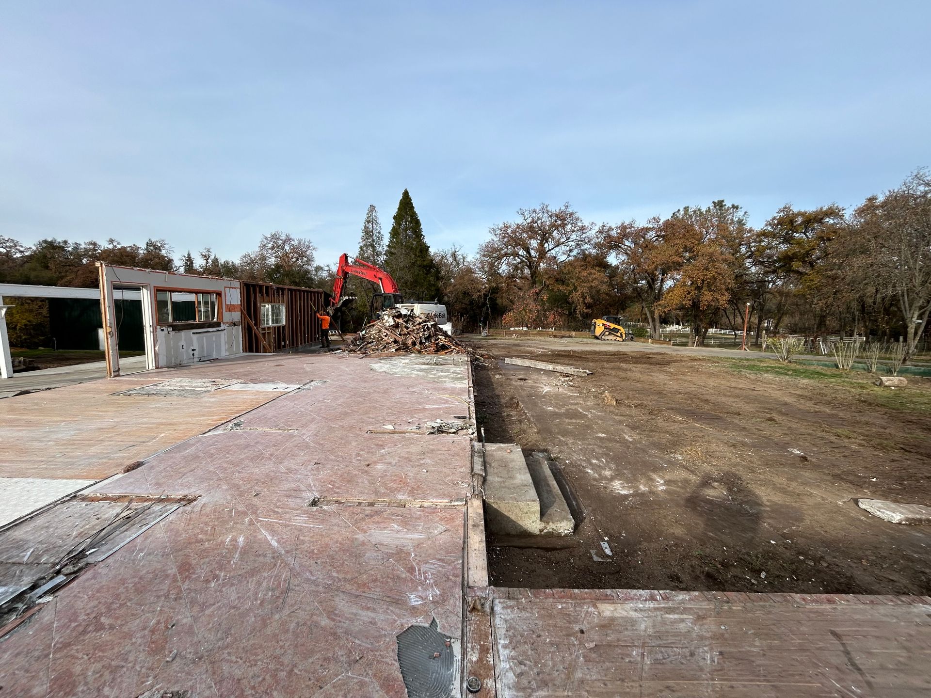 A Construction Site With a Red Excavator in the Background — Chicago, IL — Sterling Holloway Demolition