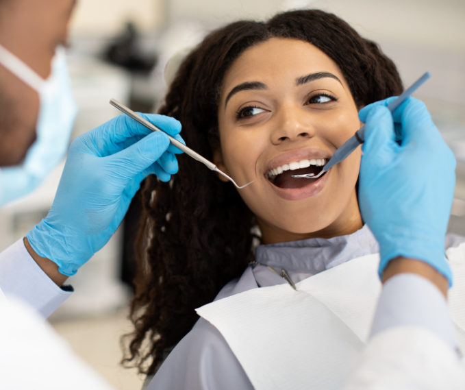 A woman is getting her teeth examined by a dentist in Michigan City, Indiana