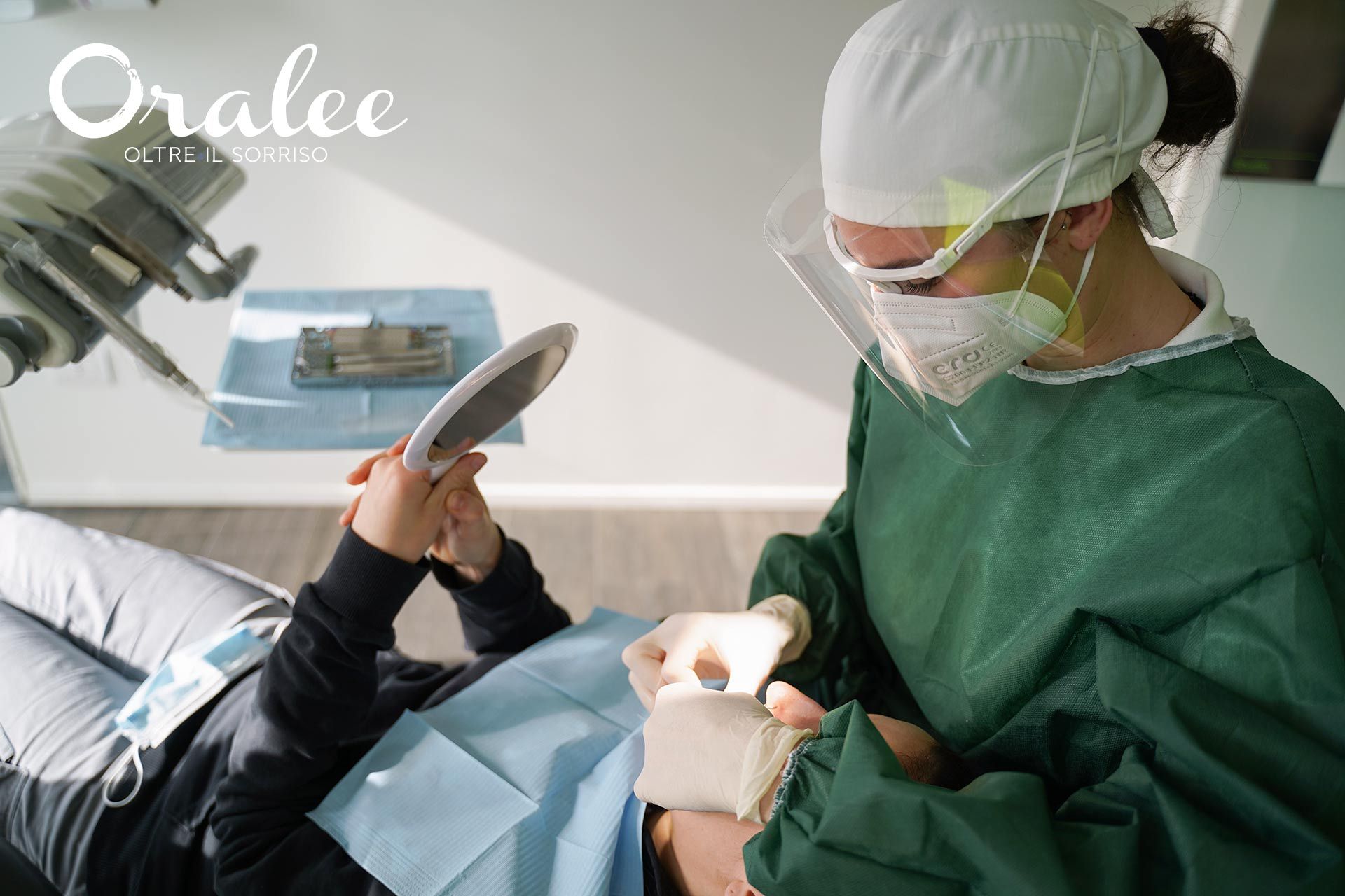 A dentist is examining a patient 's teeth in a dental office.