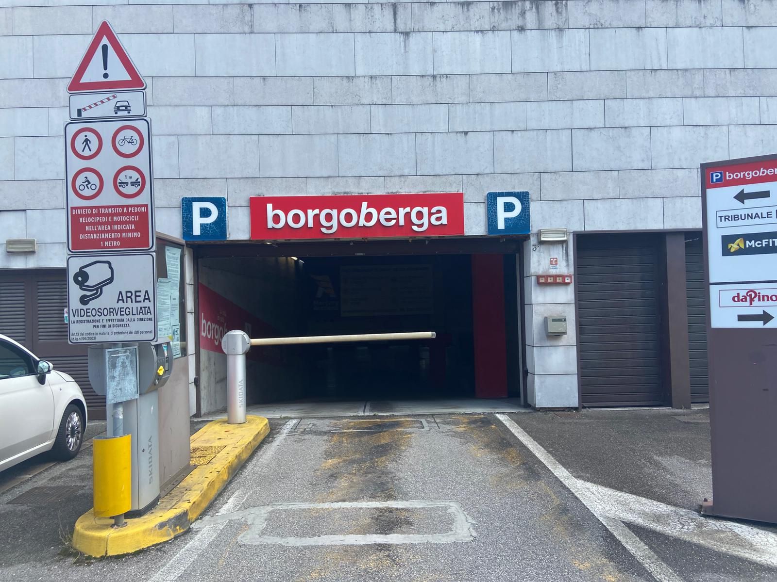 Un parcheggio con un cartello rosso che dice borgoberga