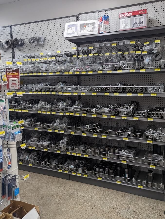 A store filled with lots of shelves filled with various HVAC items.