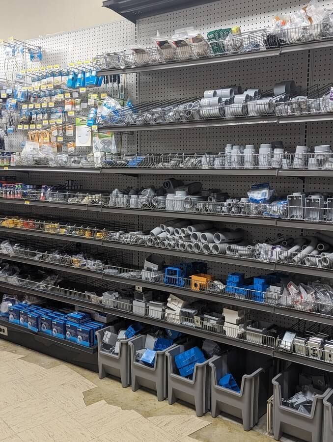 A store filled with shelves filled with lots of plumbing supplies.