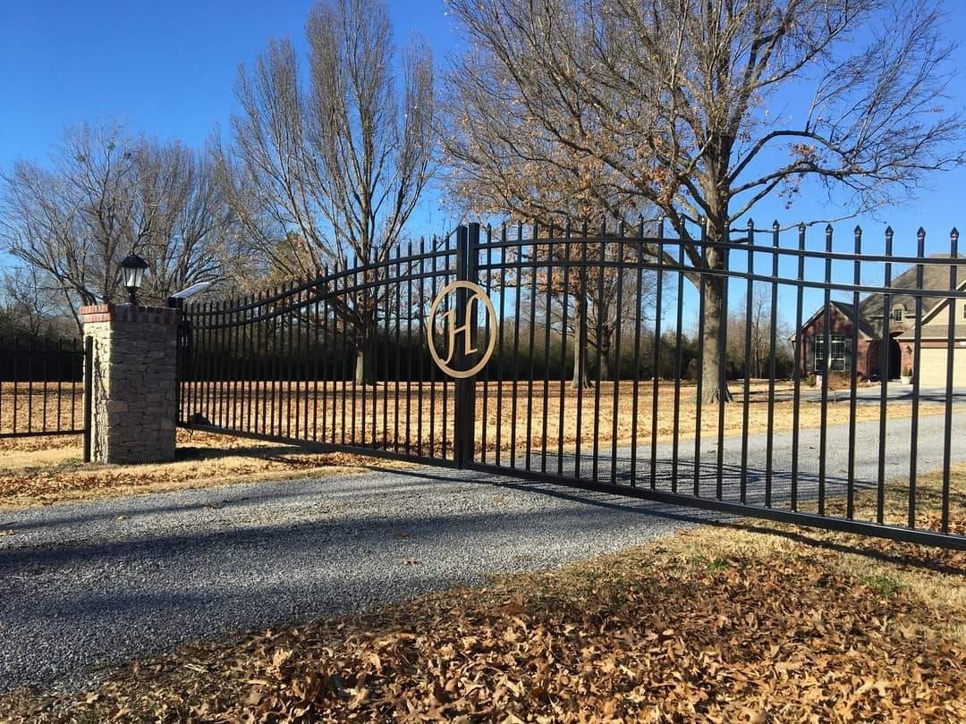 Black metal gate with a gold 