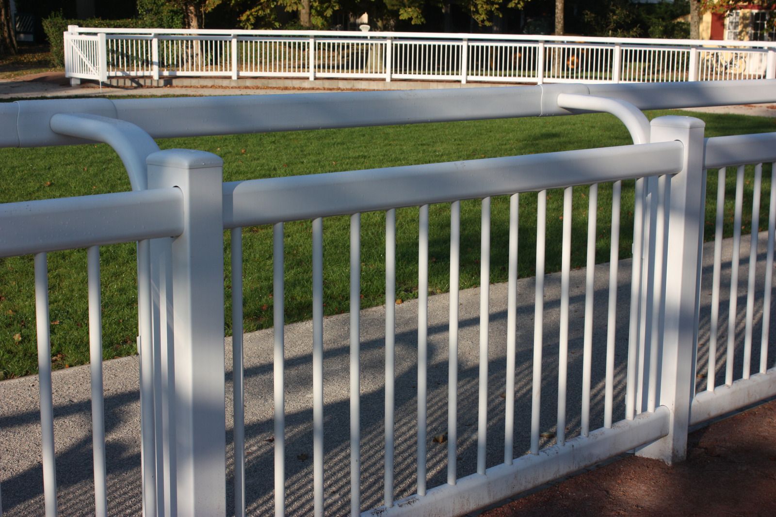 Barbed wire fence against a cloudy blue sky.