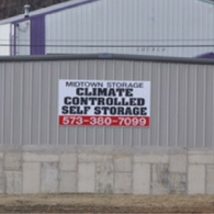 A sign on a corrugated metal building reads 