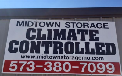 A white sign for Midtown Storage reading 