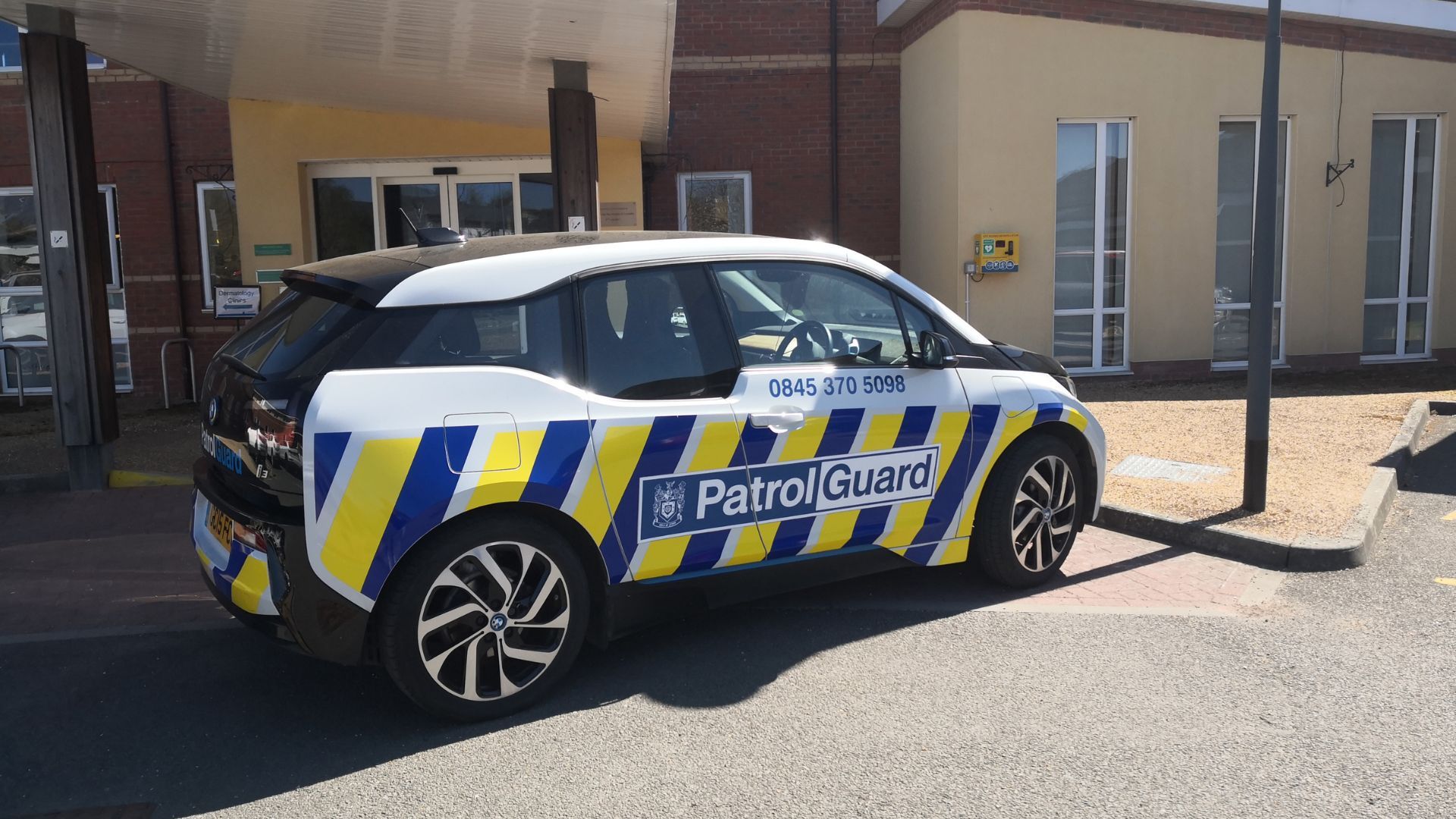 A PatrolGuard car parked outside a hospital.