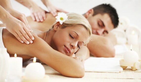 A man and a woman are getting a massage at a spa.