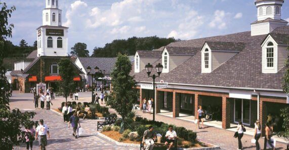 A group of people are walking around a shopping mall