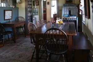 A dining room with a table and chairs in a house.