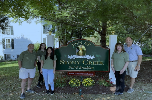 A group of people standing in front of a sign that says stony creek