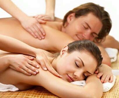 A man and a woman are getting a massage at a spa.