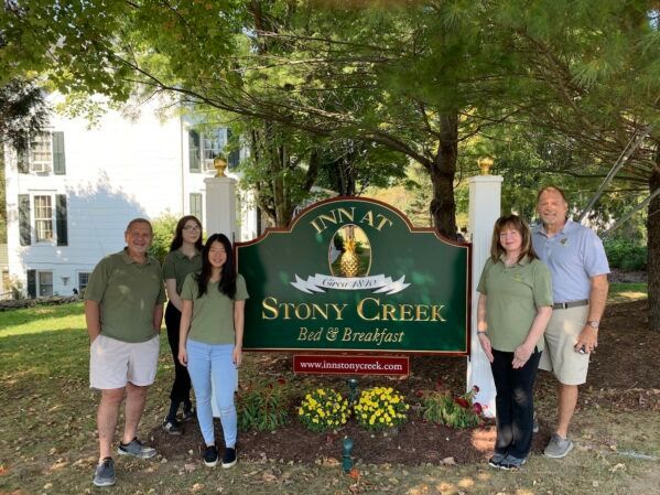 A group of people standing in front of a sign that says stony creek