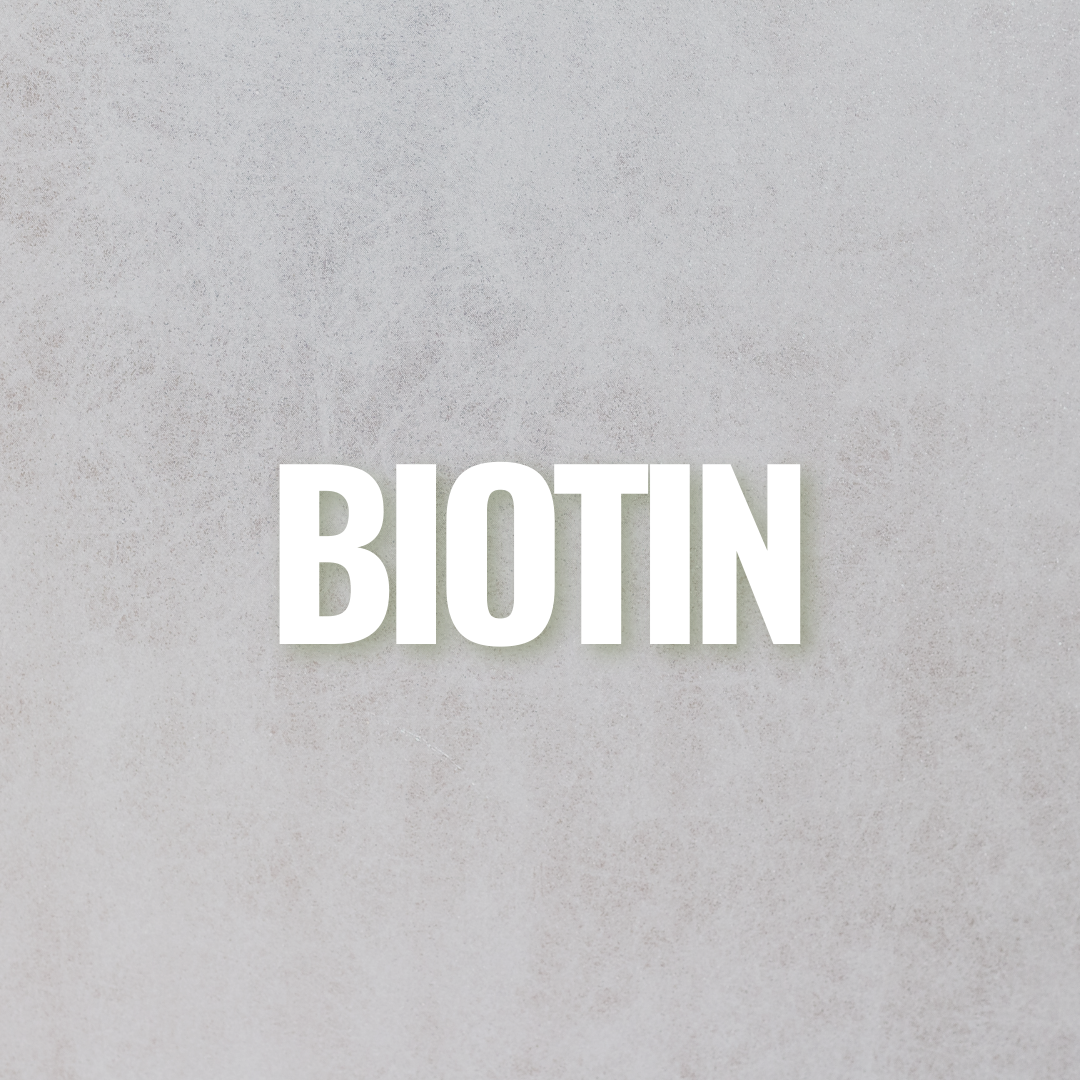 A variety of foods containing biotin on a wooden table.