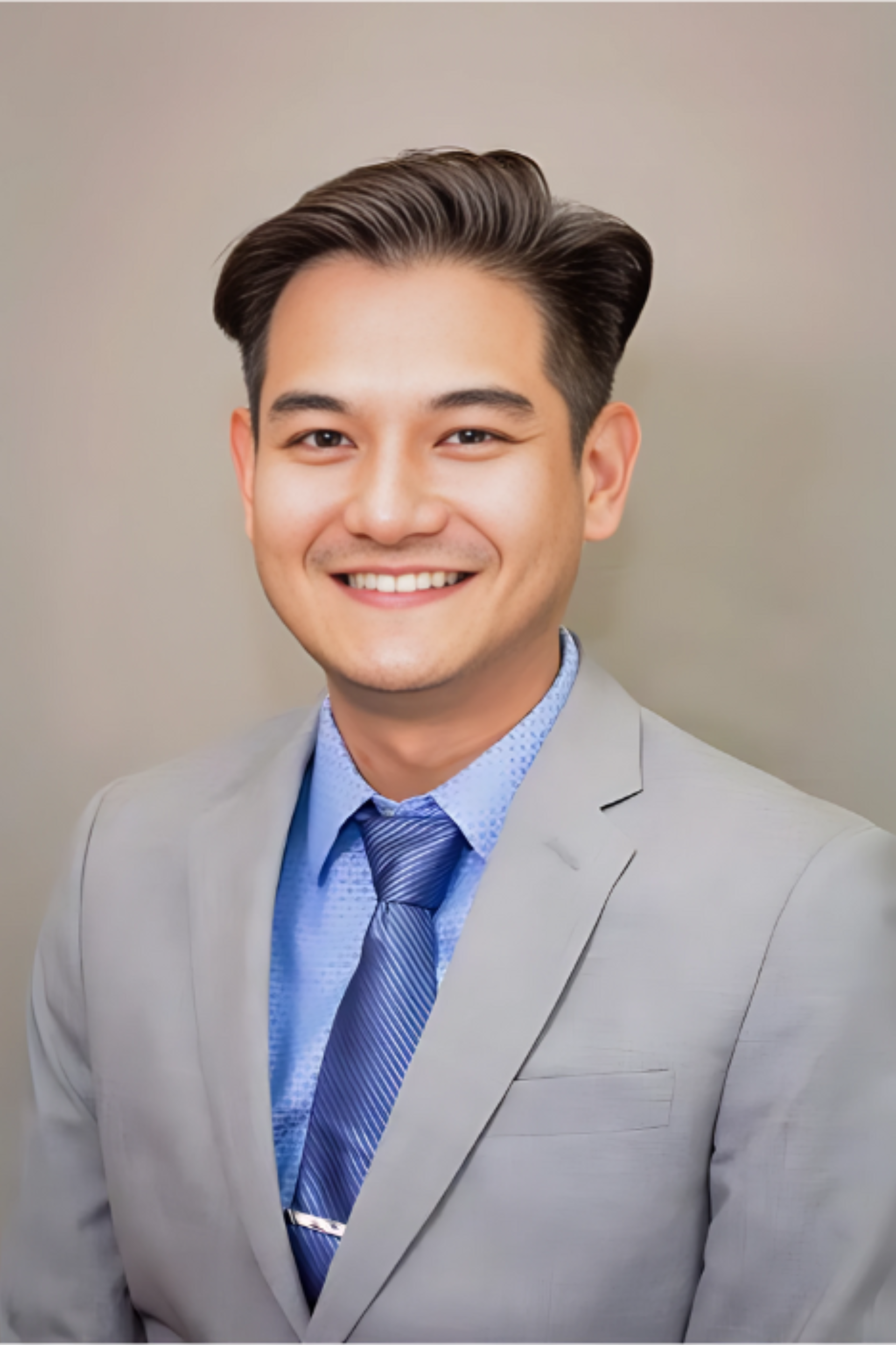 A man in a suit and tie is smiling for the camera.