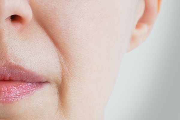 A close up of a woman 's face with wrinkles.