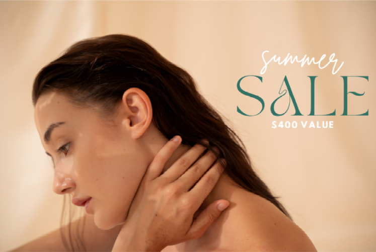 A woman is holding her neck in front of a summer sale sign.