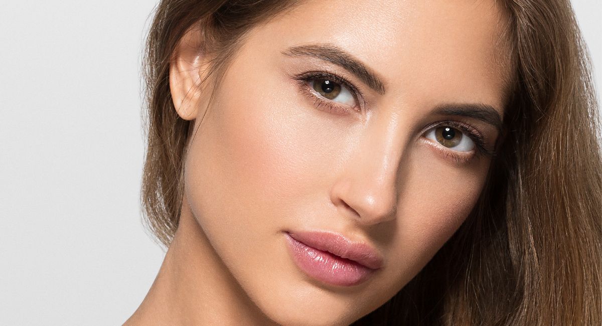 A close up of a woman 's face on a white background.