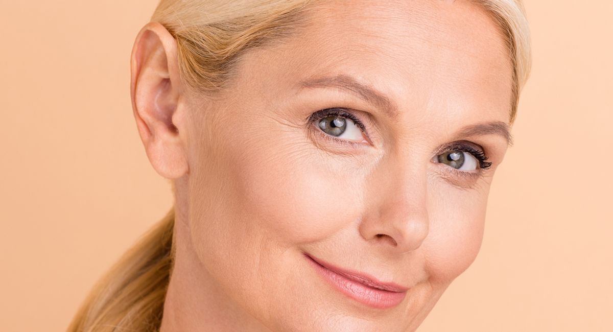 A close up of a woman 's face with a ponytail.